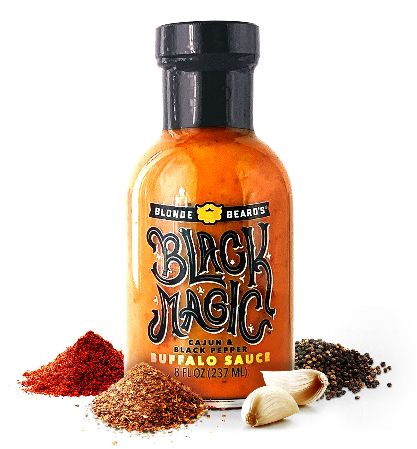 Bottle of Blonde Beard’s Black Magic buffalo wing sauce styled with fresh ingredients.