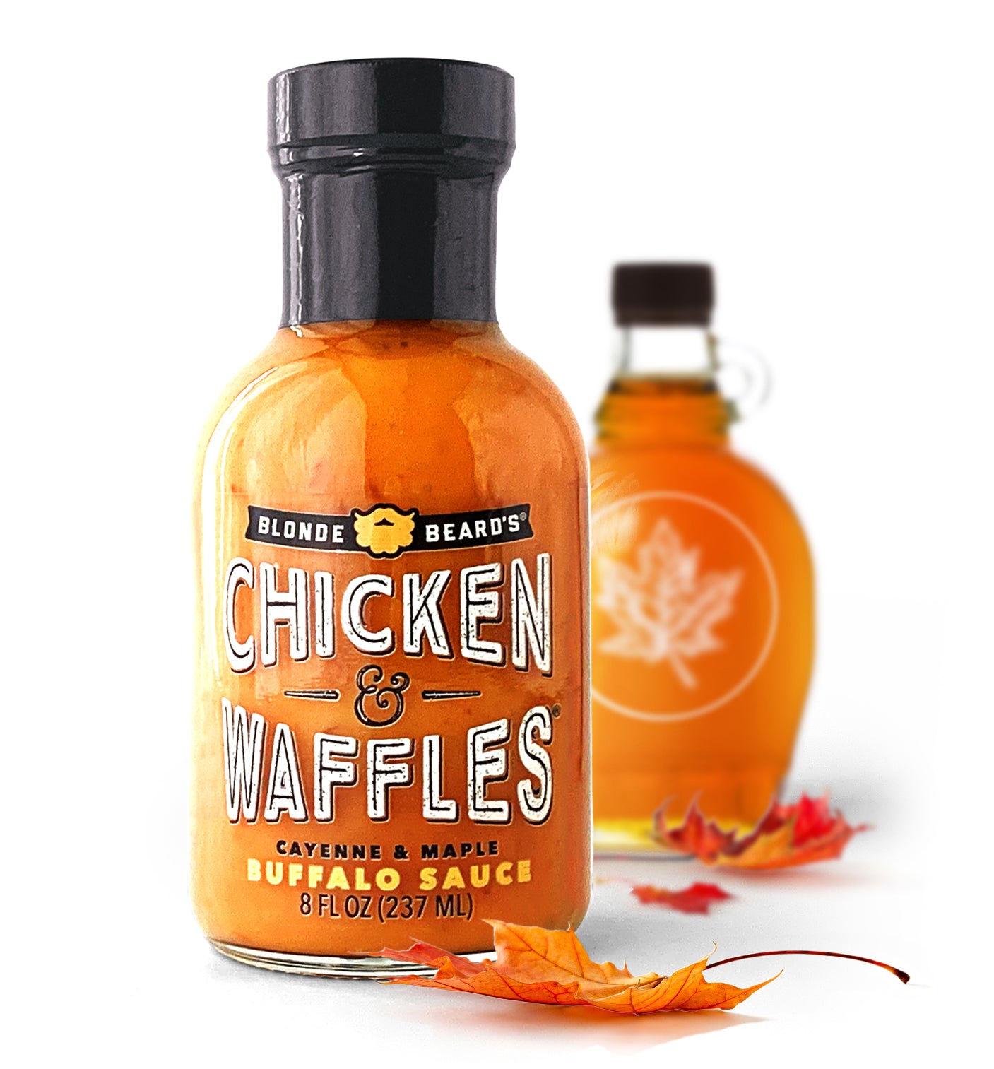 Bottle of Blonde Beard’s Chicken & Waffles buffalo wing sauce styled with maple syrup and maple leaves.