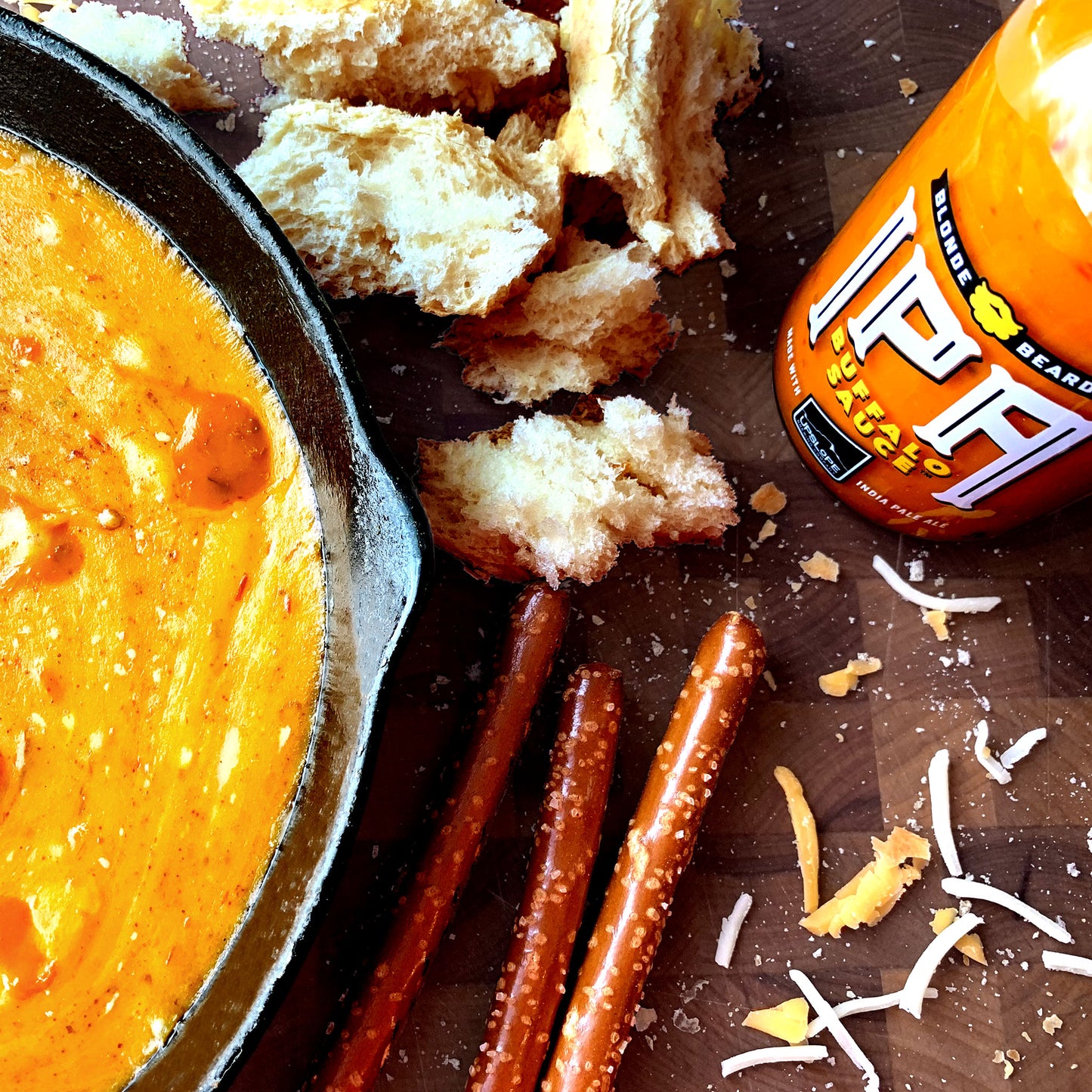 Creamy beer cheese dip made with IPA Buffalo wing sauce served with pretzel bites.